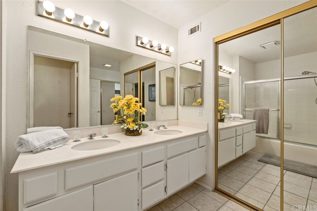 28825 Woodspring Circle Lake Forest, CA 92679 - Photo 21 of 50 a bathroom with a double vanity sink a toilet and a mirror