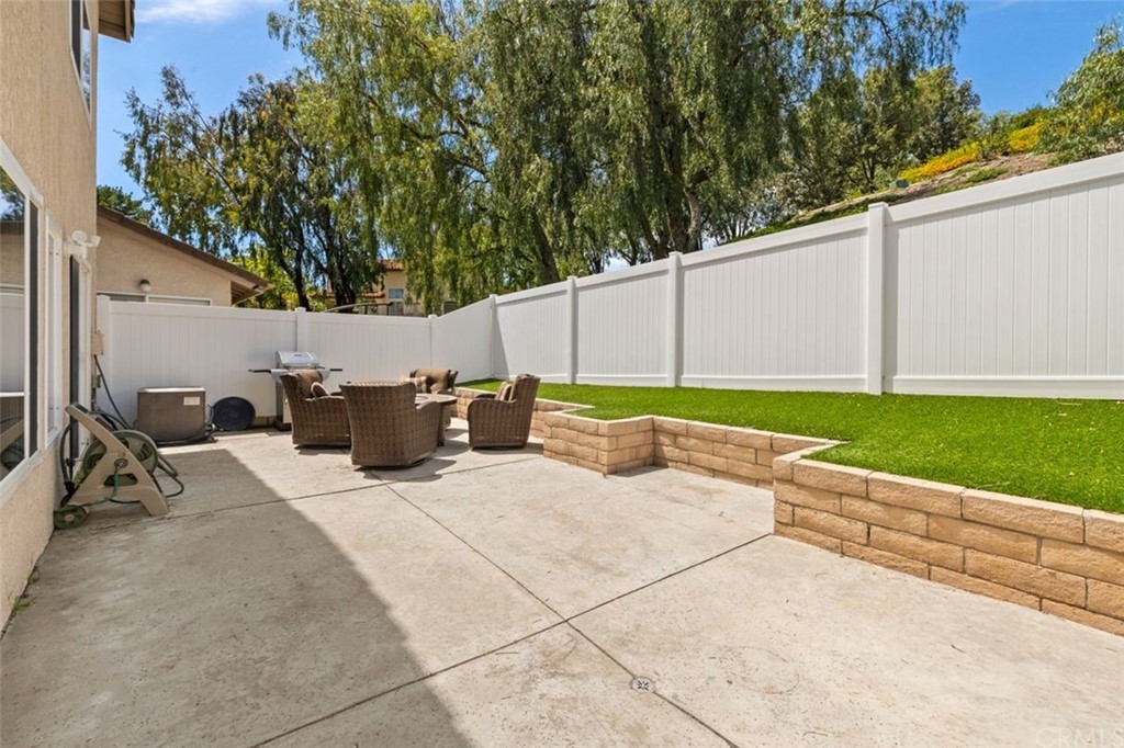 28825 Woodspring Circle Lake Forest, CA 92679 - Photo 28 of 50 a backyard of a house with table and chairs