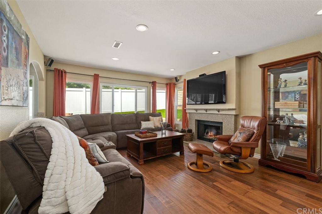 28825 Woodspring Circle Lake Forest, CA 92679 - Photo 7 of 50 a living room with furniture a fireplace and a flat screen tv