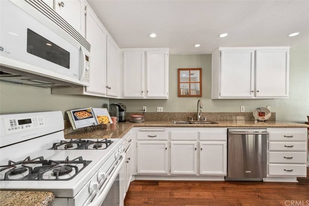 28825 Woodspring Circle Lake Forest, CA 92679 - Photo 10 of 50 a kitchen with granite countertop a sink a stove and cabinets