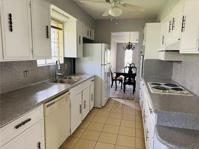 a kitchen with stainless steel appliances granite countertop a sink dishwasher stove and refrigerator