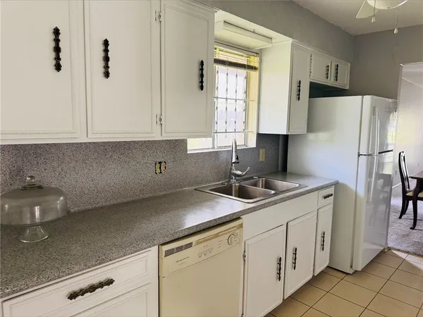 a kitchen with stainless steel appliances granite countertop a sink a refrigerator and a stove
