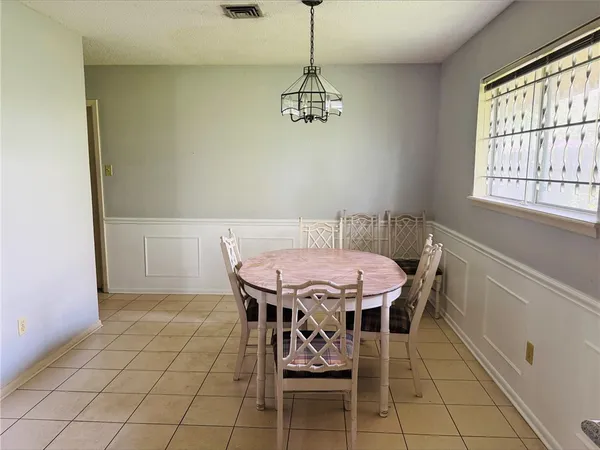 a dining room with a table and chairs