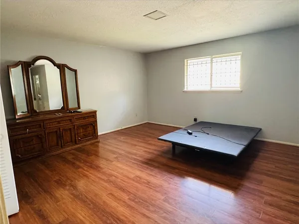 a view of a workspace with wooden floor