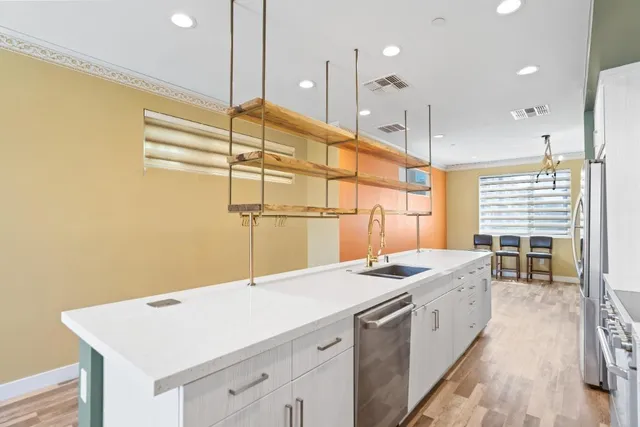 a kitchen with a sink refrigerator and microwave