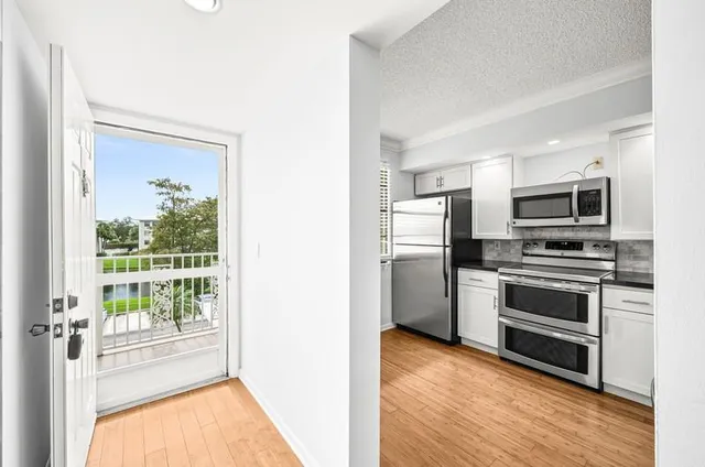 a kitchen with a refrigerator stove and microwave