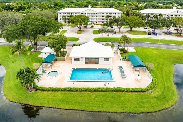 an aerial view of a house with swimming pool and outdoor seating