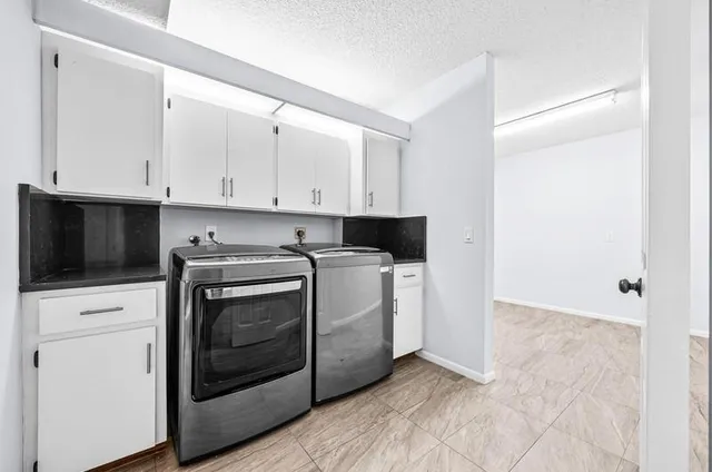 a view of a kitchen with washer and dryer