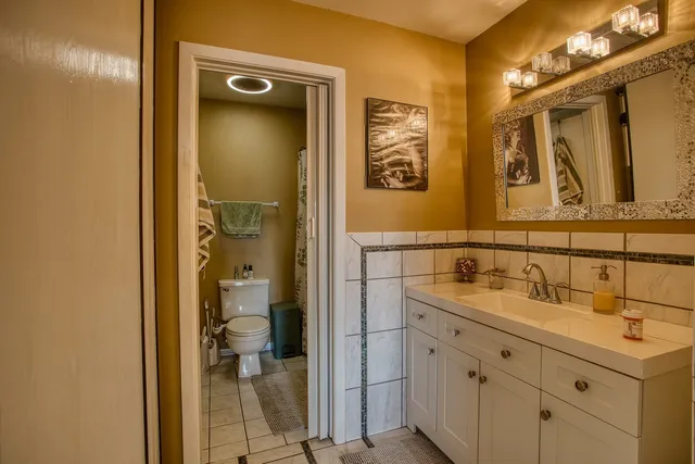 a bathroom with a shower sink and mirror