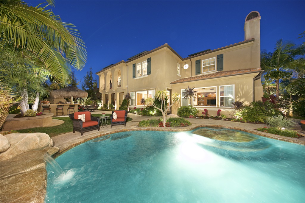 Resort Style Backyard with salt water pool & spa, fruit bearing trees, heated outdoor shower, BBQ island, large fireplace and panoramic views of La Costa Golf Course and rolling hills.