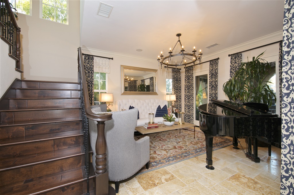 2436 Lapis Road Carlsbad, CA 92009 - Photo 7 of 25 Living area with dual doors opening up to a front yard seating area with views of the water feature and rolling hills.
