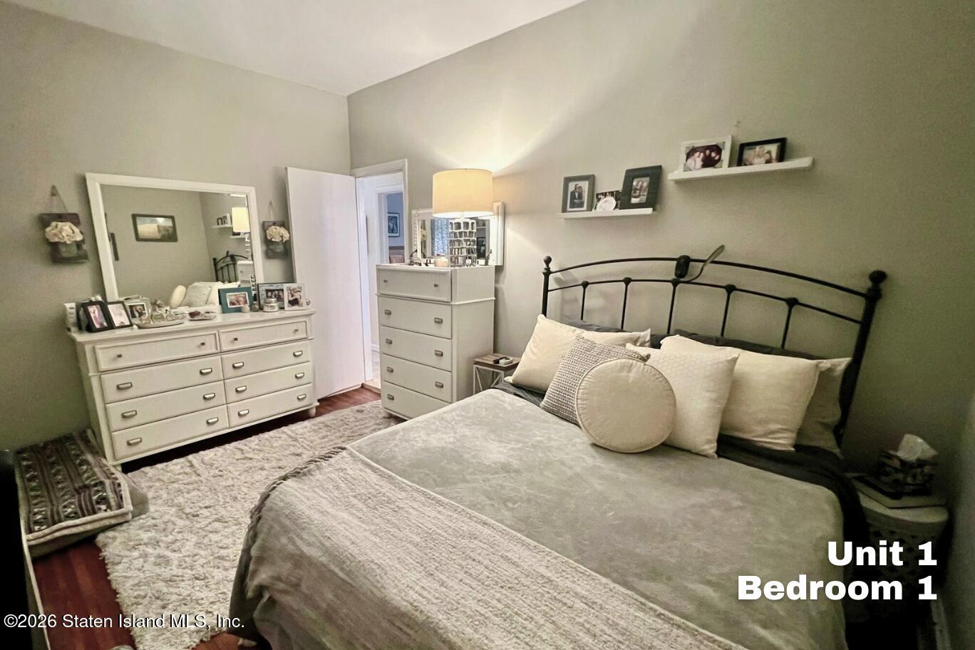 116 Silver Lake Road Staten Island, NY 10301 - Photo 11 of 36 a bedroom with a bed and cabinet