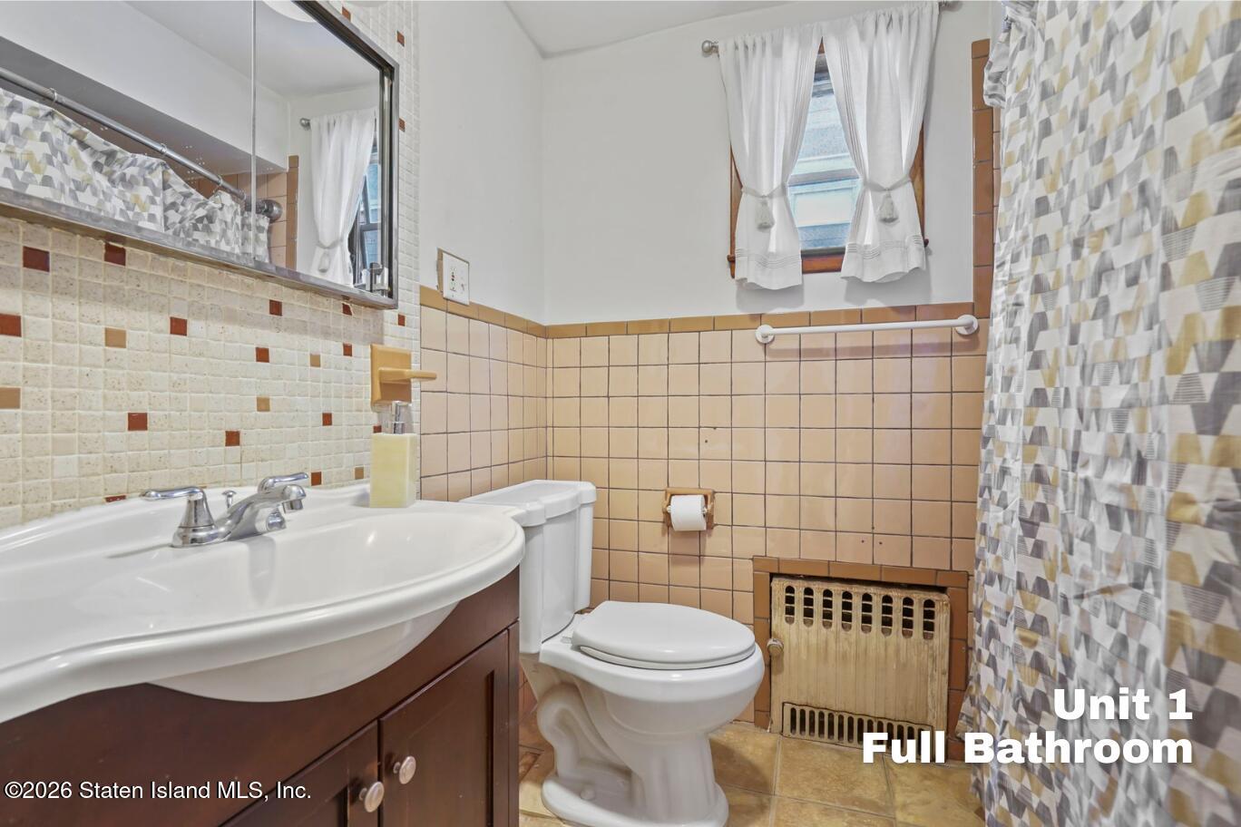 116 Silver Lake Road Staten Island, NY 10301 - Photo 16 of 36 a bathroom with a sink and a toilet