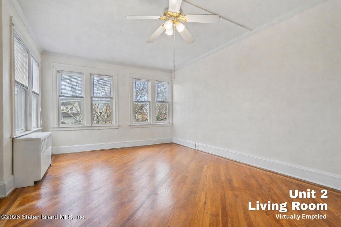 116 Silver Lake Road Staten Island, NY 10301 - Photo 19 of 36 wooden floor in an empty room with a window