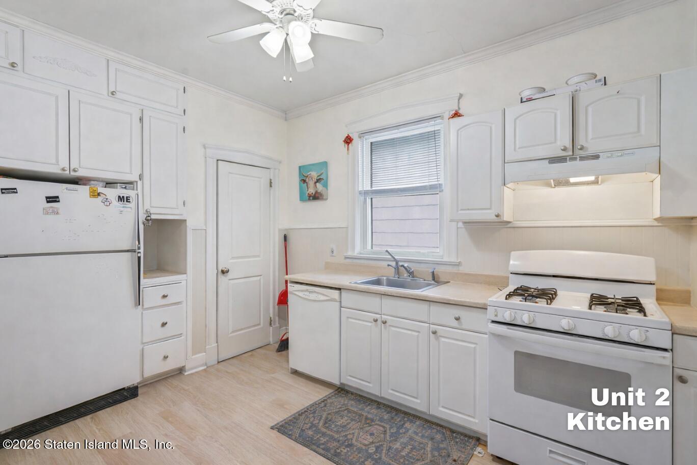 116 Silver Lake Road Staten Island, NY 10301 - Photo 23 of 36 a kitchen with white cabinets and white appliances