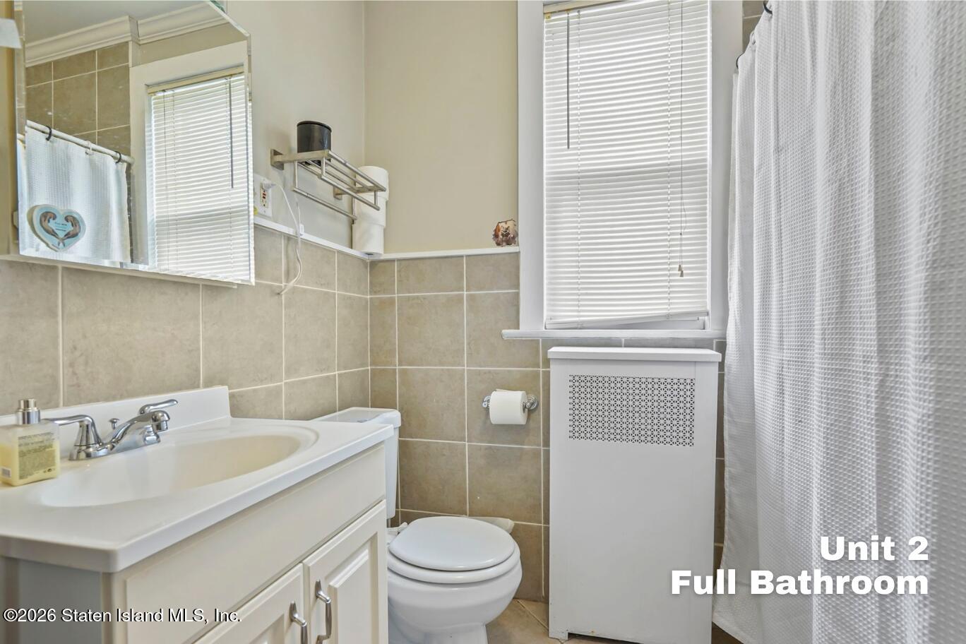 116 Silver Lake Road Staten Island, NY 10301 - Photo 27 of 36 a bathroom with a sink and toilet