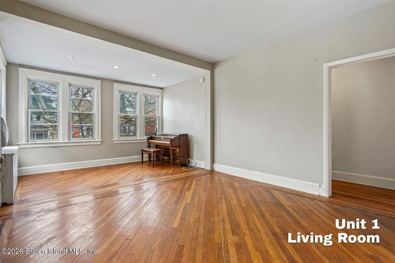 116 Silver Lake Road Staten Island, NY 10301 - Photo 3 of 36 a view of room with window and wooden floor