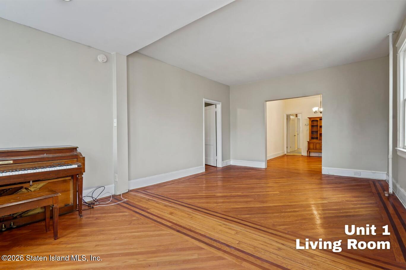 116 Silver Lake Road Staten Island, NY 10301 - Photo 4 of 36 a view of an empty room with wooden floor