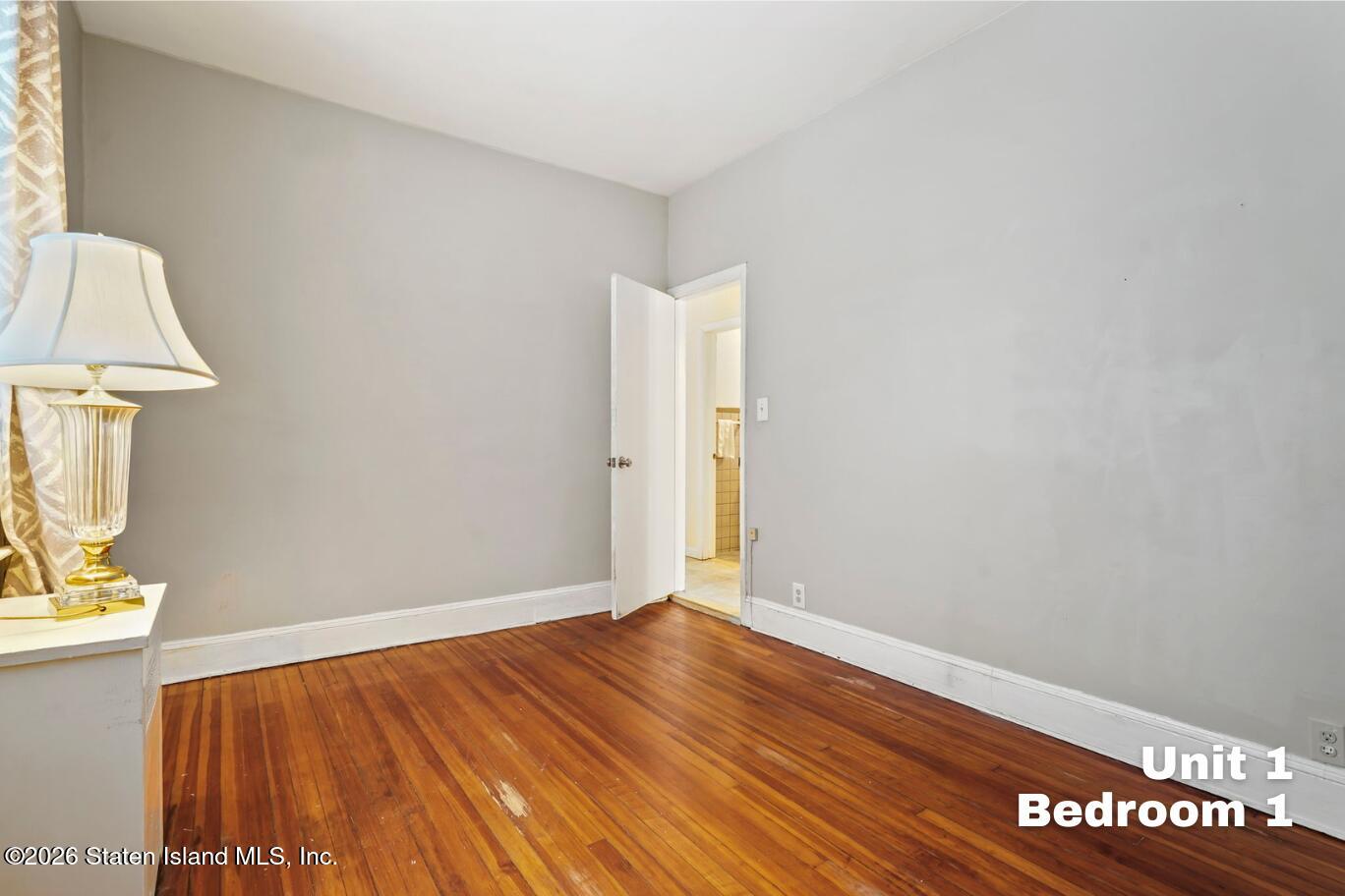 116 Silver Lake Road Staten Island, NY 10301 - Photo 9 of 36 a view of room with wooden floor