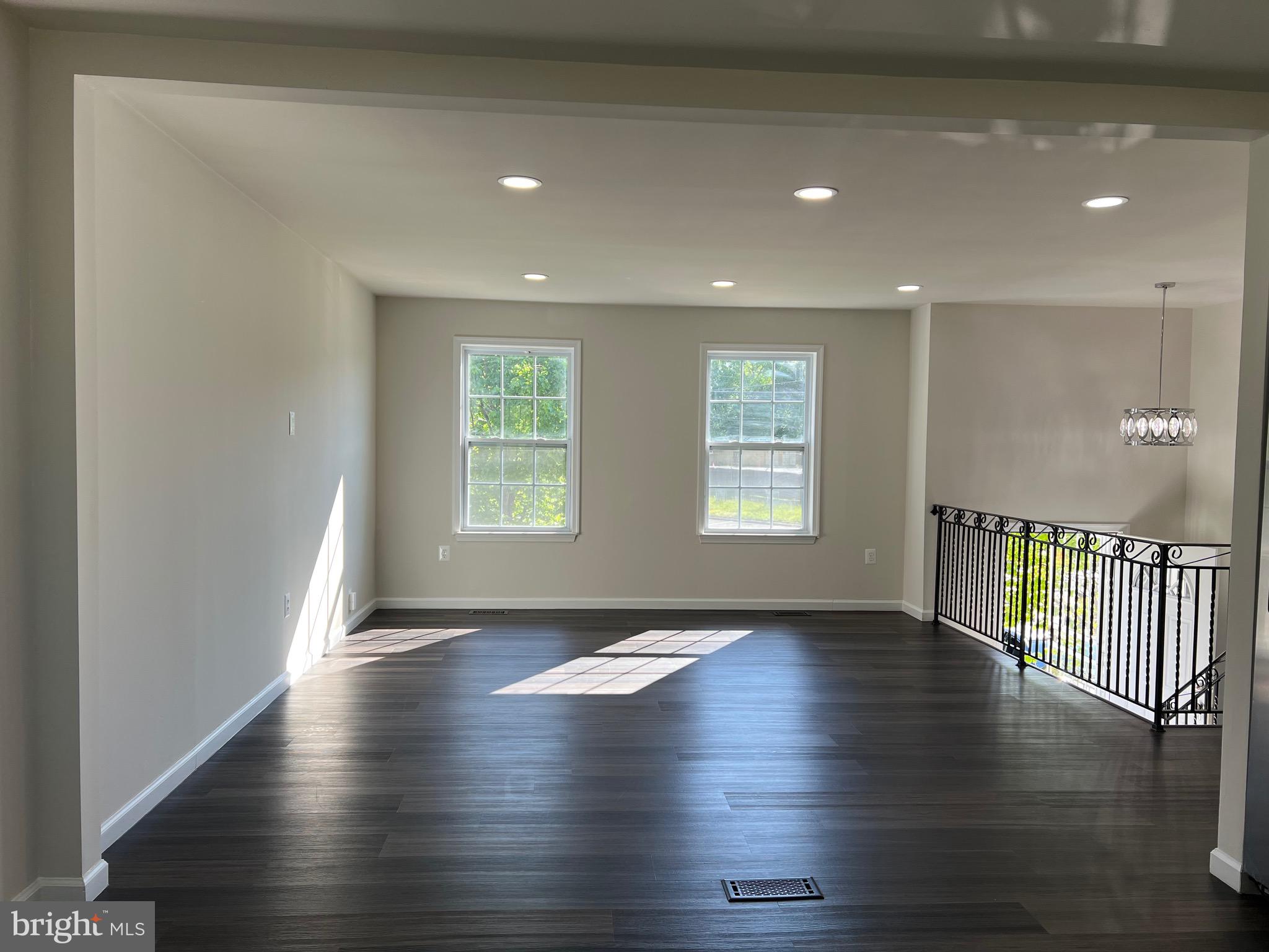 6604 Suitland Road Suitland, MD 20746 - Photo 9 of 27 an empty room with wooden floor and windows