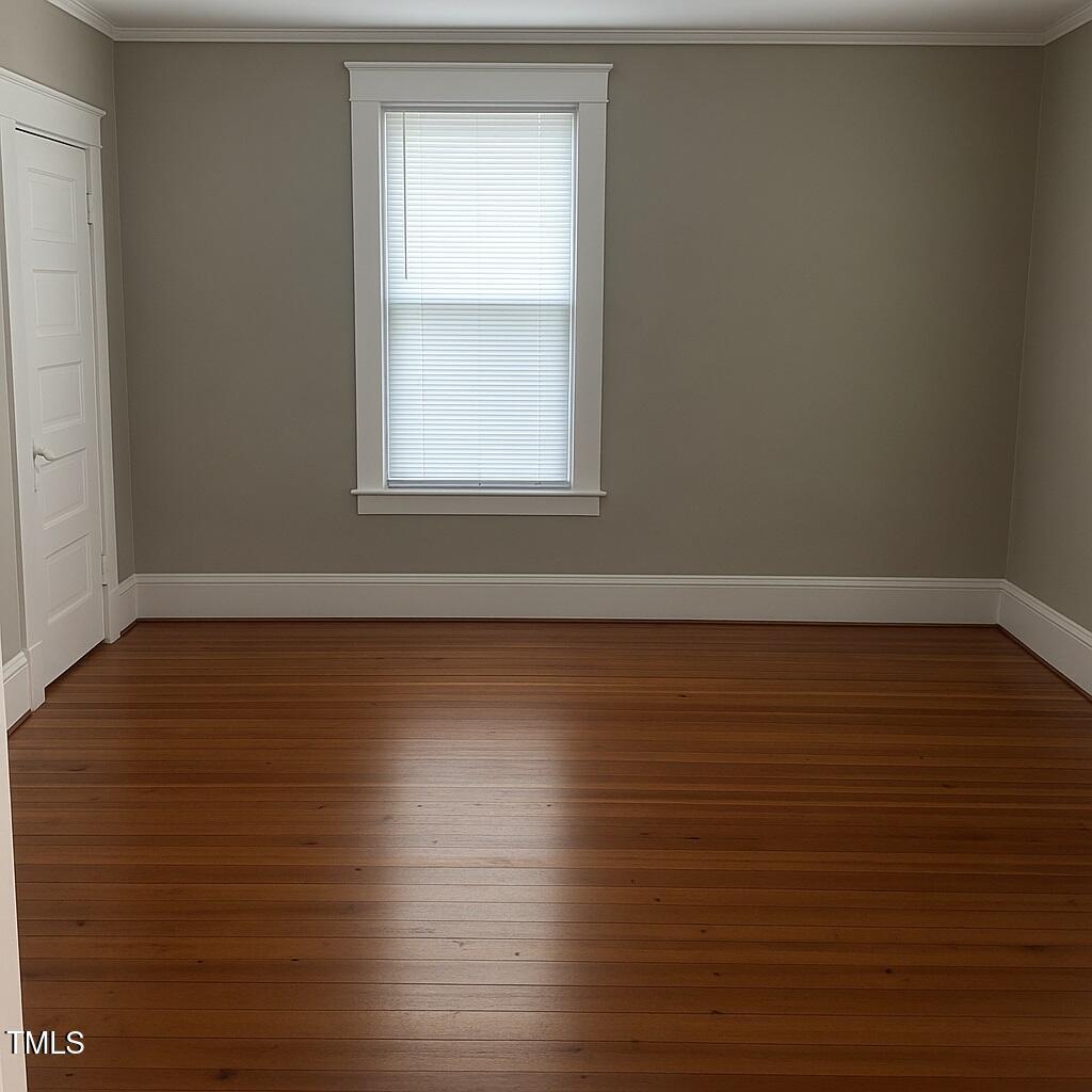 23 Dixie Trail Raleigh, NC 27607 - Photo 4 of 7 an empty room with wooden floor and windows