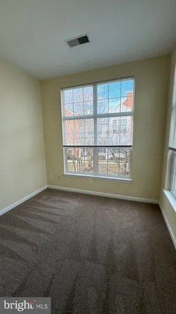 a view of an empty room with a ceiling fan