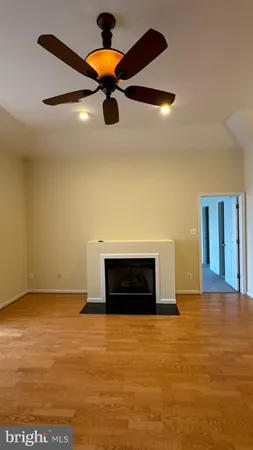 an empty room with a ceiling fan and a window