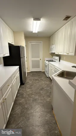 a kitchen with a refrigerator and a stove