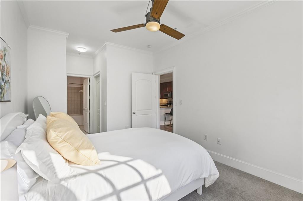 1055 Piedmont Avenue Northeast, Unit 309 Atlanta, GA 30309 - Photo 11 of 23 a bedroom with a bed and a chandelier