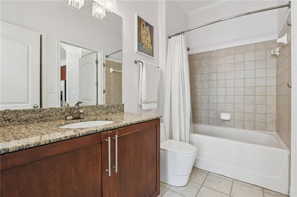 1055 Piedmont Avenue Northeast, Unit 309 Atlanta, GA 30309 - Photo 12 of 23 a bathroom with a granite countertop sink toilet and shower