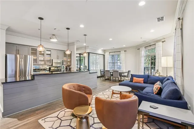 a kitchen with stainless steel appliances granite countertop a stove a sink island and a refrigerator