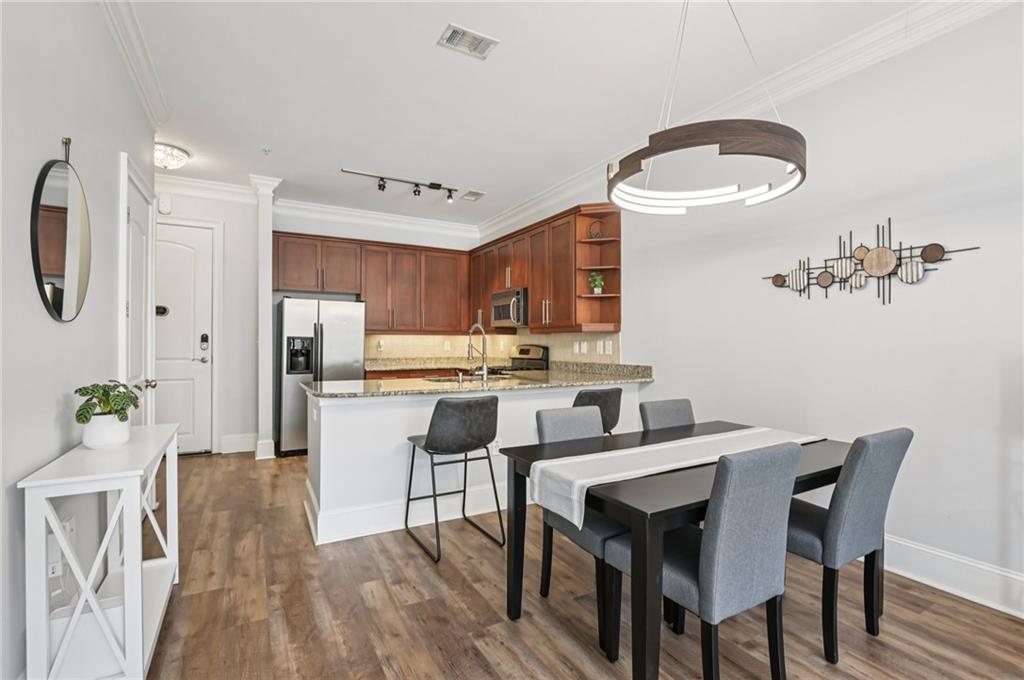 1055 Piedmont Avenue Northeast, Unit 309 Atlanta, GA 30309 - Photo 2 of 23 a view of a dining room with furniture and wooden floor