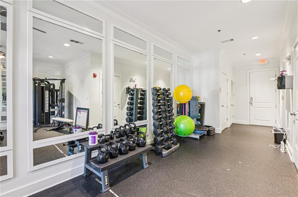 1055 Piedmont Avenue Northeast, Unit 309 Atlanta, GA 30309 - Photo 21 of 23 a room with lots of gym equipment and glass windows
