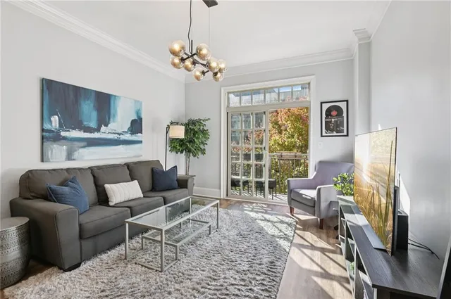 a living room with furniture and a chandelier