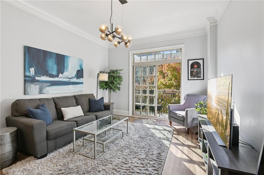 1055 Piedmont Avenue Northeast, Unit 309 Atlanta, GA 30309 - Photo 6 of 23 a living room with furniture and a chandelier