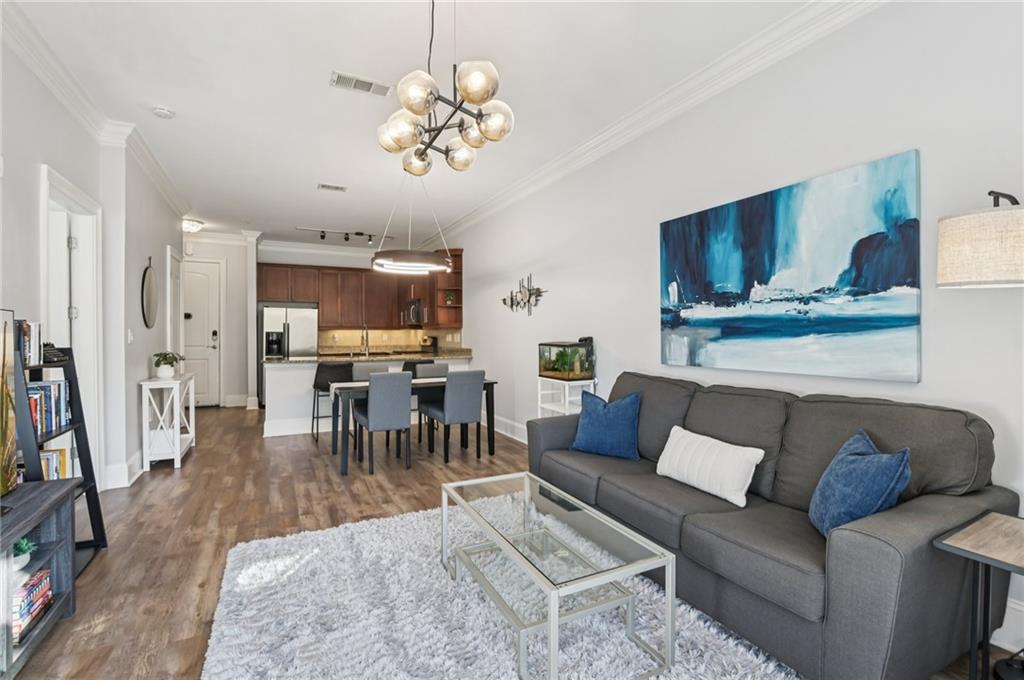 1055 Piedmont Avenue Northeast, Unit 309 Atlanta, GA 30309 - Photo 7 of 23 a living room with furniture wooden floor and a chandelier