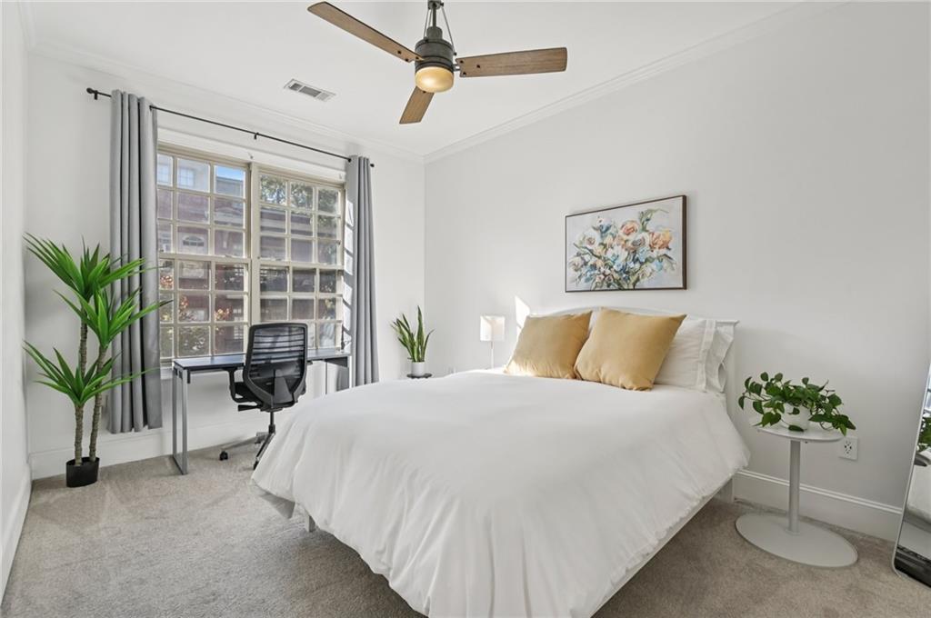 1055 Piedmont Avenue Northeast, Unit 309 Atlanta, GA 30309 - Photo 10 of 23 a bedroom with a large bed and a potted plant