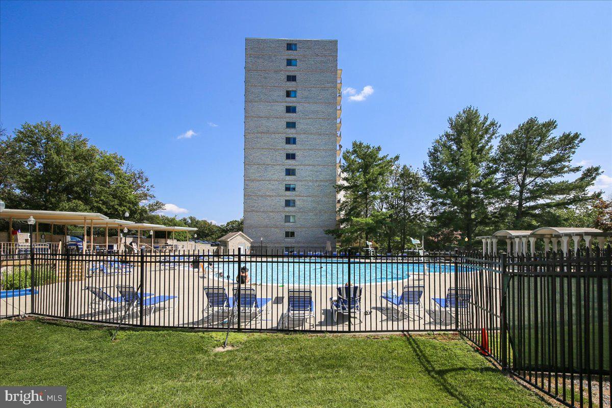 1111 University Boulevard West, Unit 1106A Silver Spring, MD 20902 - Photo 25 of 35 a view of a deck with a big yard