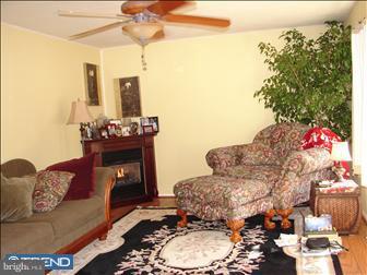 294 Jones Kane Road Williamstown, NJ 08094 - Photo 6 of 6 a living room with furniture and a chandelier