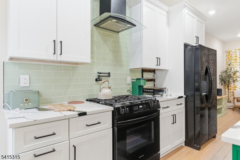 16 Eagles Street Newark, NJ 07102 - Photo 8 of 35 a kitchen with stainless steel appliances a stove a refrigerator and a cabinets