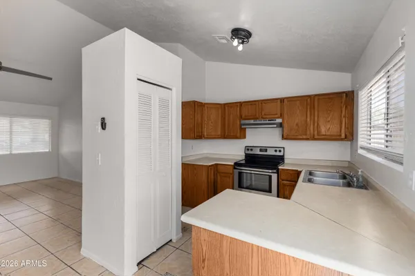 a kitchen with stainless steel appliances a sink stove and cabinets