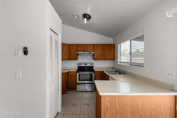 a kitchen with a sink stove and cabinets