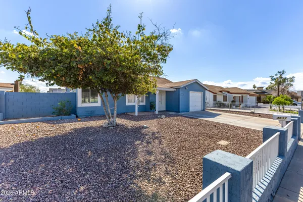 a house that has a tree in front of it