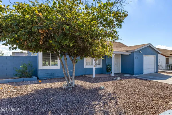 a view of an empty room and chandelier fan
