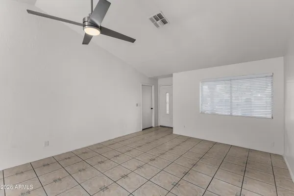 a view of a livingroom with a ceiling fan and window