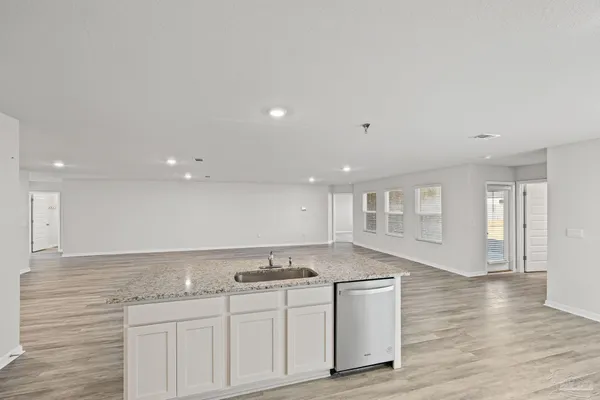 a kitchen with stainless steel appliances granite countertop a sink and cabinets