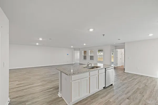 a kitchen with a stove top oven sink and cabinets
