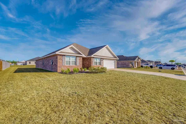 a view of backyard of house and garage