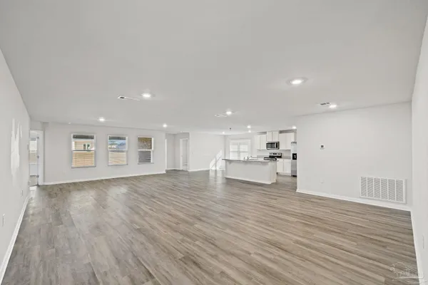 a view of kitchen with kitchen island sink and refrigerator