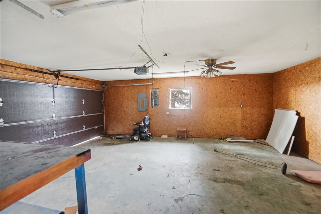 9750 Middlepoint Road Middle Point, OH 45863 - Photo 35 of 43 This spacious garage offers versatile utility, featuring a concrete floor and a practical ceiling fan.